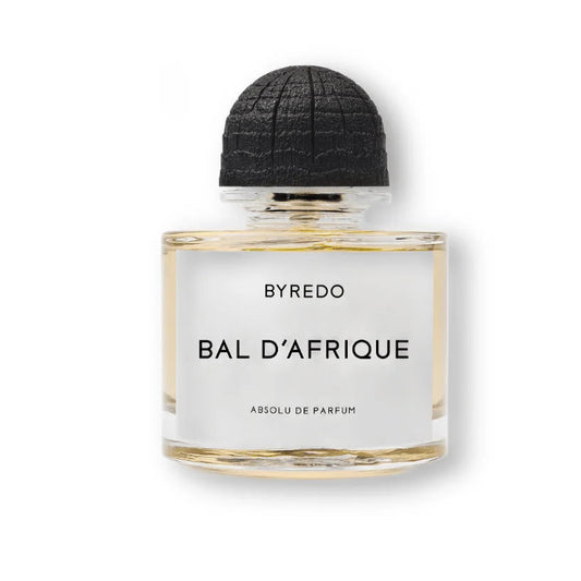A bottle of BYREDO Bal D'Afrique perfume with a clear glass body, pale yellow liquid, a white label with black text, and a textured black cap, centered on a white background.